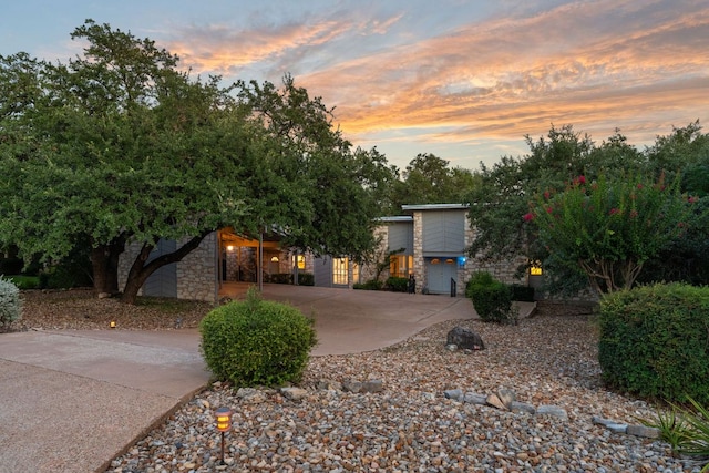 605 Flamingo Blvd, Lakeway, TX 78734 - modern home featuring stone siding and curved driveway