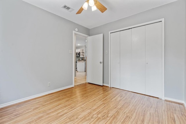 2207 Shoalmont Dr, Austin, TX 78756 - unfurnished bedroom with wood finished floors, a closet, and a ceiling fan
