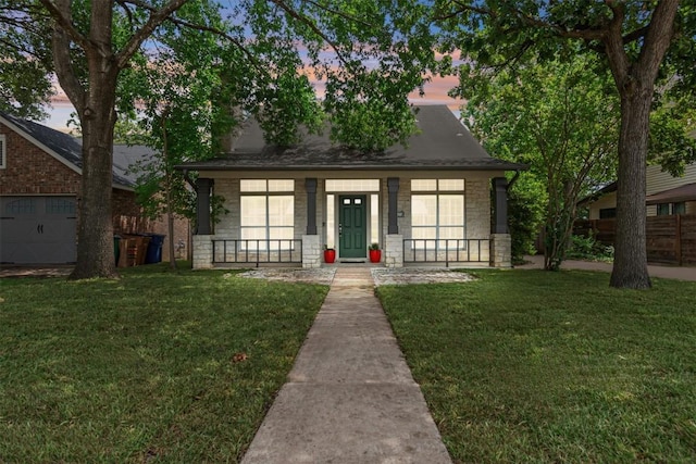 2207 Shoalmont Dr, Austin, TX 78756 - view of front facade featuring covered porch, a yard, a garage, roof with shingles, and stone siding