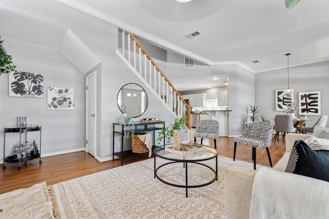 2207 Shoalmont Dr, Austin, TX 78756 - living room featuring wood finished floors, stairs, and crown molding