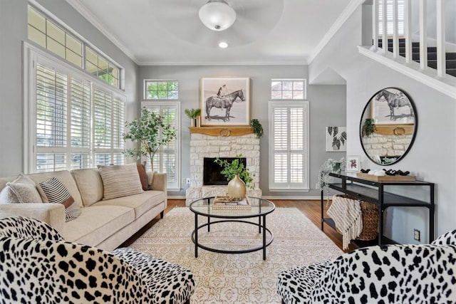 2207 Shoalmont Dr, Austin, TX 78756 - living area featuring crown molding, a stone fireplace, wood finished floors, and ceiling fan