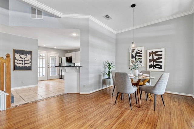 2207 Shoalmont Dr, Austin, TX 78756 - dining room featuring french doors, ornamental molding, light wood-style floors, and recessed lighting