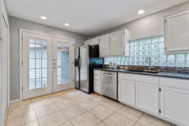 2207 Shoalmont Dr, Austin, TX 78756 - kitchen with stainless steel appliances, french doors, decorative backsplash, white cabinetry, and recessed lighting