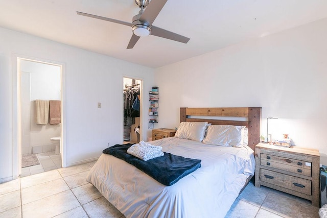 1106 Saucedo St, Austin, TX 78721 - tiled bedroom featuring a spacious closet, ensuite bath, and ceiling fan