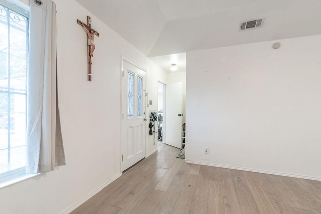1106 Saucedo St, Austin, TX 78721 - spare room featuring light wood-style floors and vaulted ceiling