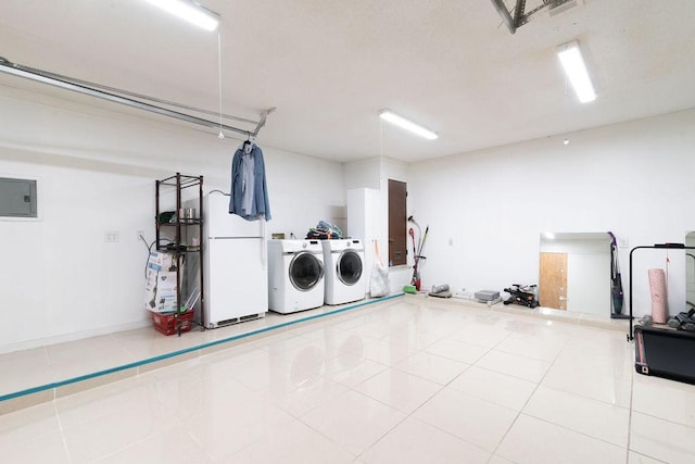 1106 Saucedo St, Austin, TX 78721 - laundry area with washer and dryer, a garage, tile patterned flooring, and electric panel