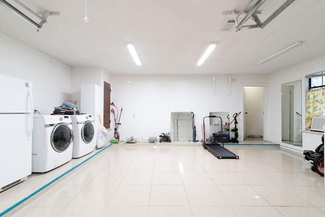 1106 Saucedo St, Austin, TX 78721 - washroom with independent washer and dryer, a garage, and tile patterned floors