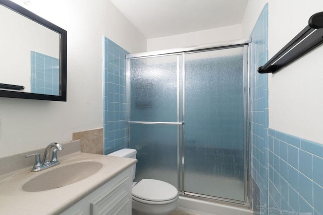 1106 Saucedo St, Austin, TX 78721 - bathroom featuring a shower stall, vanity, and tile walls