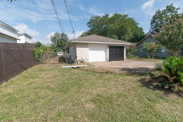 1106 Saucedo St, Austin, TX 78721 - view of yard featuring a detached garage, driveway, and an outbuilding