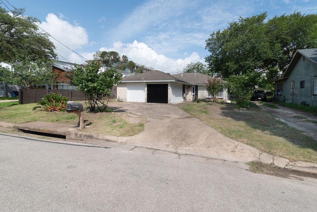 1106 Saucedo St, Austin, TX 78721 - single story home with an attached garage and concrete driveway