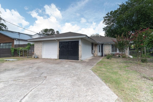 1106 Saucedo St, Austin, TX 78721 - ranch-style house with a garage and driveway