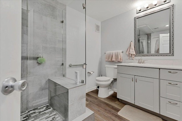 2320 Gracy Farms Ln Unit 918, Austin, TX 78758 - full bathroom with vanity, a shower stall, and wood finished floors