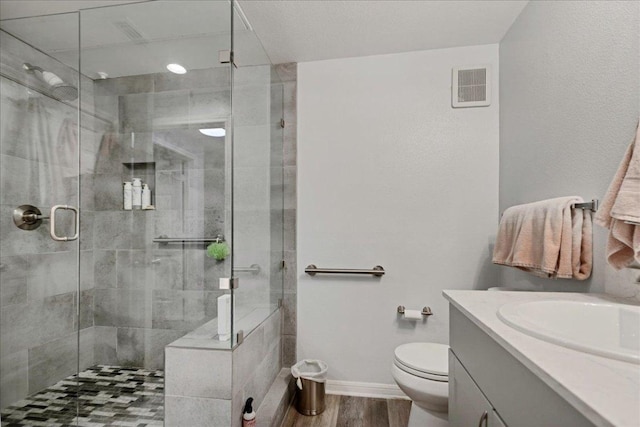 2320 Gracy Farms Ln Unit 918, Austin, TX 78758 - bathroom featuring wood finished floors, vanity, and a shower stall