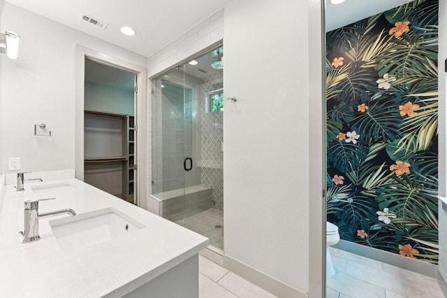2004 Pennsylvania Ave Unit A, Austin, TX 78702 - bathroom with a stall shower, double vanity, tile patterned flooring, a spacious closet, and recessed lighting