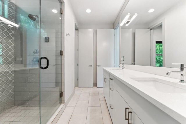 2004 Pennsylvania Ave Unit A, Austin, TX 78702 - bathroom with double vanity, tile patterned floors, a shower stall, and recessed lighting