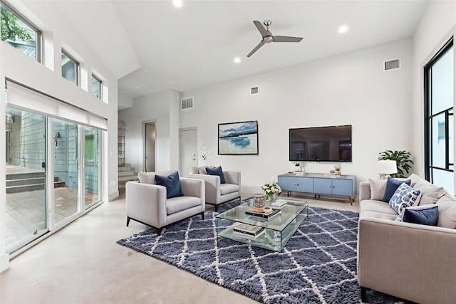 2004 Pennsylvania Ave Unit A, Austin, TX 78702 - living room featuring a towering ceiling, a ceiling fan, recessed lighting, finished concrete floors, and stairs