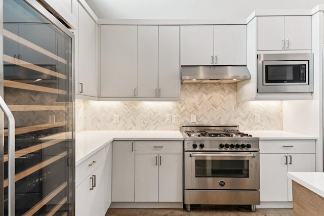 2004 Pennsylvania Ave Unit A, Austin, TX 78702 - kitchen featuring under cabinet range hood, appliances with stainless steel finishes, beverage cooler, and light countertops