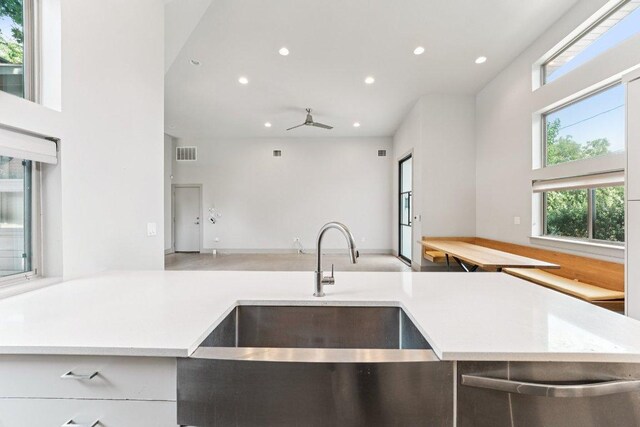2004 Pennsylvania Ave Unit A, Austin, TX 78702 - kitchen with open floor plan, recessed lighting, ceiling fan, and light countertops