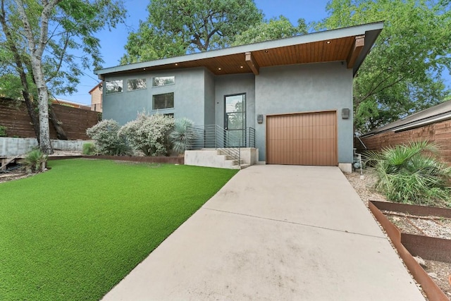 2004 Pennsylvania Ave Unit A, Austin, TX 78702 - view of front of property featuring stucco siding, driveway, and a garage