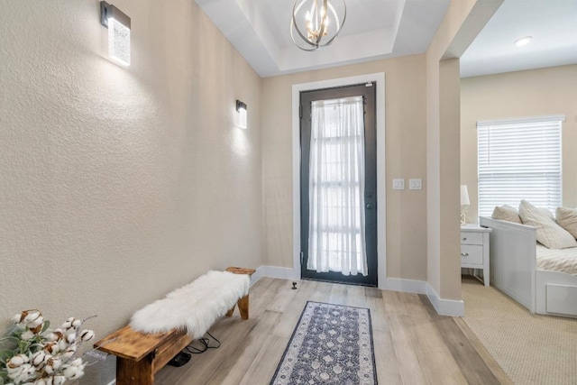 1332 Brescia Walk, Leander, TX 78641 - entryway featuring a chandelier, light wood-type flooring, and a textured wall
