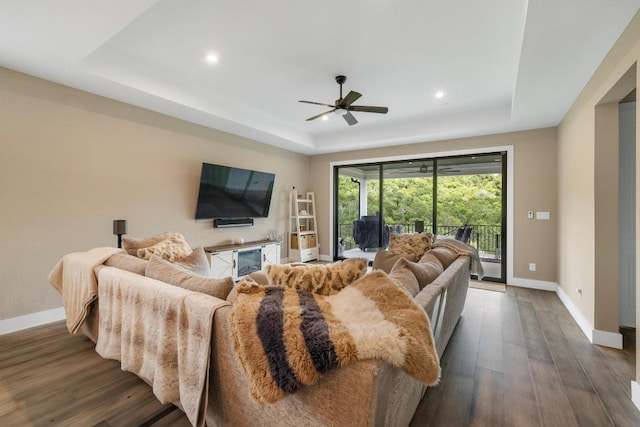 1332 Brescia Walk, Leander, TX 78641 - living area with a tray ceiling, dark wood-style flooring, a ceiling fan, and recessed lighting