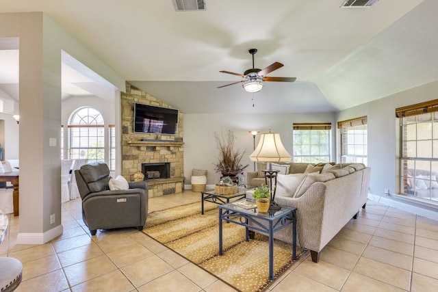 604 Cutty Trl, Lakeway, TX 78734 - living room featuring lofted ceiling, light tile patterned floors, ceiling fan, and a stone fireplace
