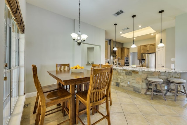 604 Cutty Trl, Lakeway, TX 78734 - dining space with light tile patterned floors and a chandelier