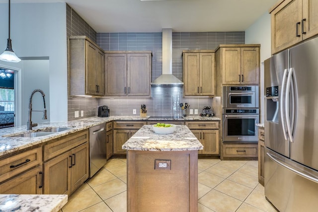 604 Cutty Trl, Lakeway, TX 78734 - kitchen with stainless steel appliances, wall chimney range hood, light tile patterned floors, a center island, and decorative backsplash