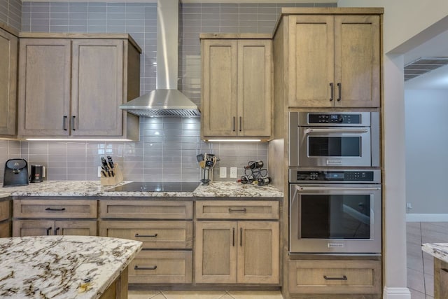 604 Cutty Trl, Lakeway, TX 78734 - kitchen with wall chimney exhaust hood, black electric stovetop, double oven, and light stone counters