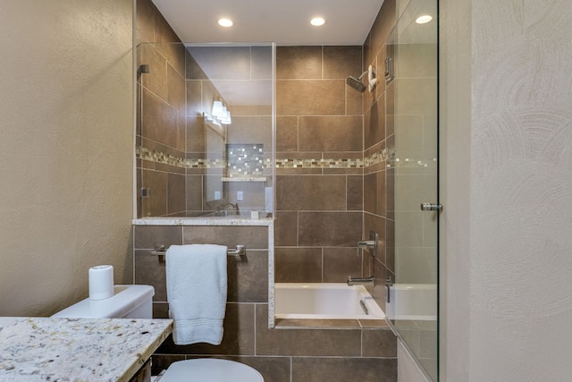 604 Cutty Trl, Lakeway, TX 78734 - bathroom featuring recessed lighting, vanity, tiled shower / bath, and a textured wall