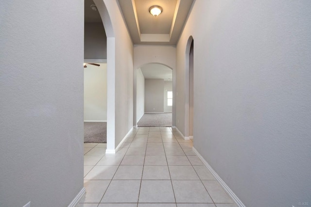 21016 Abigail Way, Pflugerville, TX 78660 - hall with arched walkways, light tile patterned floors, light colored carpet, and a textured wall