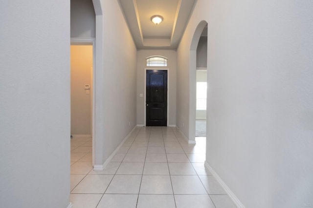 21016 Abigail Way, Pflugerville, TX 78660 - hallway with light tile patterned floors, arched walkways, and a raised ceiling