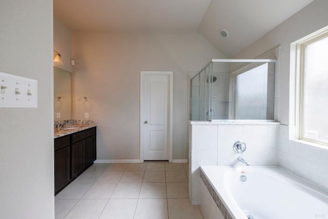21016 Abigail Way, Pflugerville, TX 78660 - bathroom with vanity, a bath, a stall shower, vaulted ceiling, and tile patterned flooring