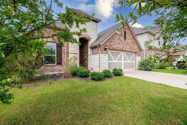 21016 Abigail Way, Pflugerville, TX 78660 - view of front of home with an attached garage, driveway, a front yard, and stone siding