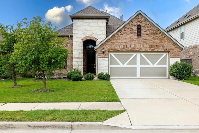 21016 Abigail Way, Pflugerville, TX 78660 - french country home with a shingled roof, an attached garage, stone siding, driveway, and a front lawn