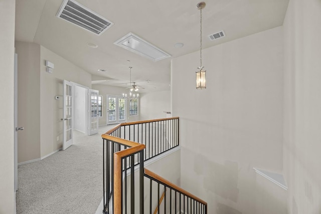 1310 Parmer Ln W Unit 3201, Austin, TX 78727 - hallway featuring attic access, an upstairs landing, carpet floors, and french doors