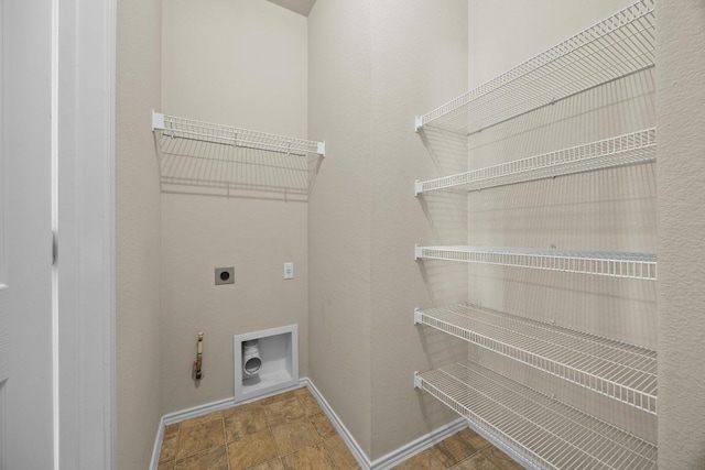 1310 Parmer Ln W Unit 3201, Austin, TX 78727 - washroom with hookup for an electric dryer, hookup for a gas dryer, and stone finish floors