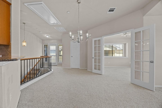 1310 Parmer Ln W Unit 3201, Austin, TX 78727 - corridor with french doors, light colored carpet, an upstairs landing, and attic access