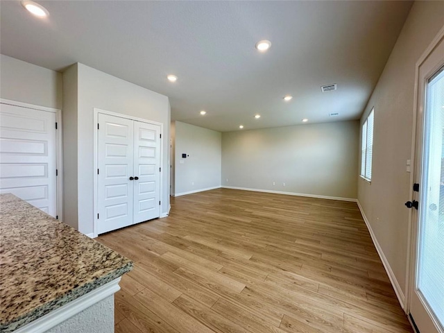 149 Gullivers Dr, Elgin, TX 78621 - unfurnished living room featuring light wood-style floors and recessed lighting