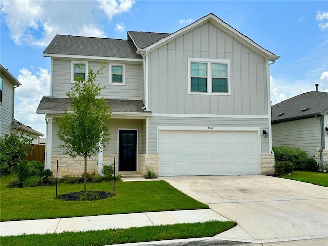 149 Gullivers Dr, Elgin, TX 78621 - craftsman-style home with board and batten siding, a garage, a front yard, concrete driveway, and stone siding