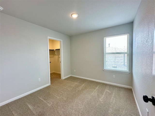 149 Gullivers Dr, Elgin, TX 78621 - unfurnished bedroom featuring carpet flooring and a walk in closet