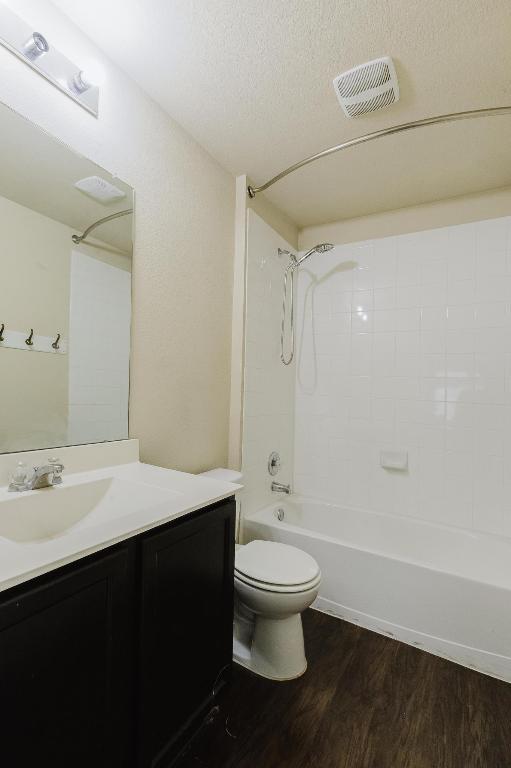 184 Voss St, Kyle, TX 78640 - bathroom with vanity, wood finished floors, and shower / tub combination