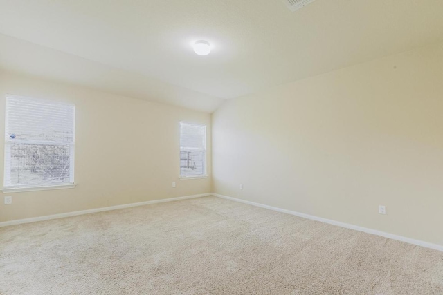 184 Voss St, Kyle, TX 78640 - spare room with light carpet, healthy amount of natural light, and vaulted ceiling