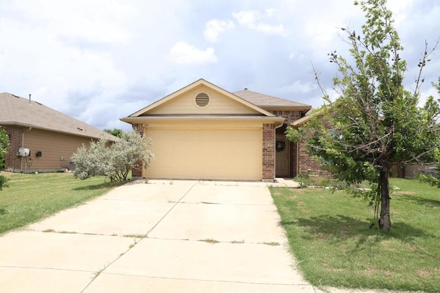184 Voss St, Kyle, TX 78640 - single story home with driveway, brick siding, a garage, and a front yard