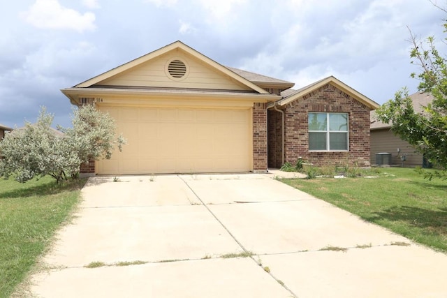 184 Voss St, Kyle, TX 78640 - ranch-style house with an attached garage, concrete driveway, brick siding, and a front lawn