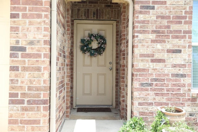 184 Voss St, Kyle, TX 78640 - view of exterior entry featuring brick siding