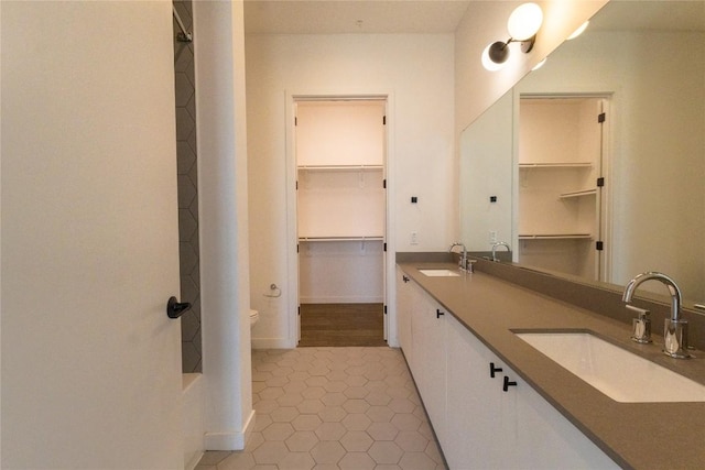 800 Embassy Dr Unit 137, Austin, TX 78702 - bathroom featuring double vanity, tile patterned floors, and a spacious closet