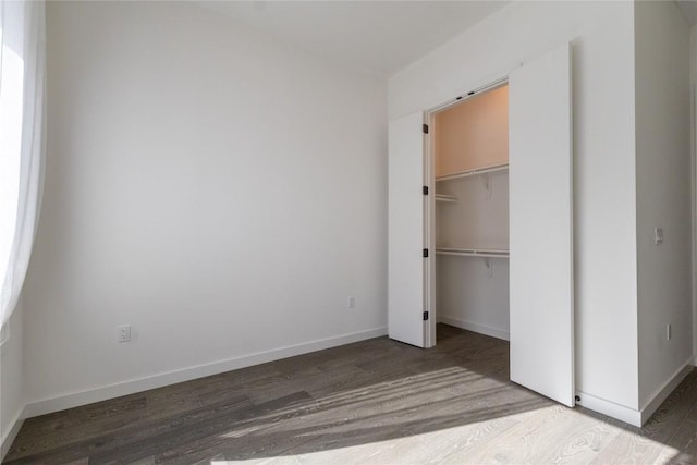 800 Embassy Dr Unit 137, Austin, TX 78702 - unfurnished bedroom with wood finished floors and a spacious closet