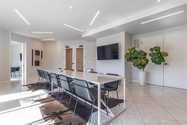 800 Embassy Dr Unit 137, Austin, TX 78702 - kitchen featuring light tile patterned floors, a kitchen breakfast bar, light countertops, and a large island