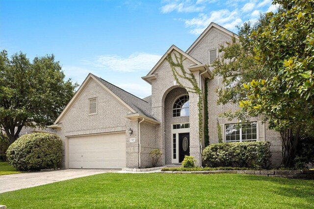 3416 Oxsheer Dr, Austin, TX 78732 - traditional-style home with brick siding, concrete driveway, a front lawn, and a garage